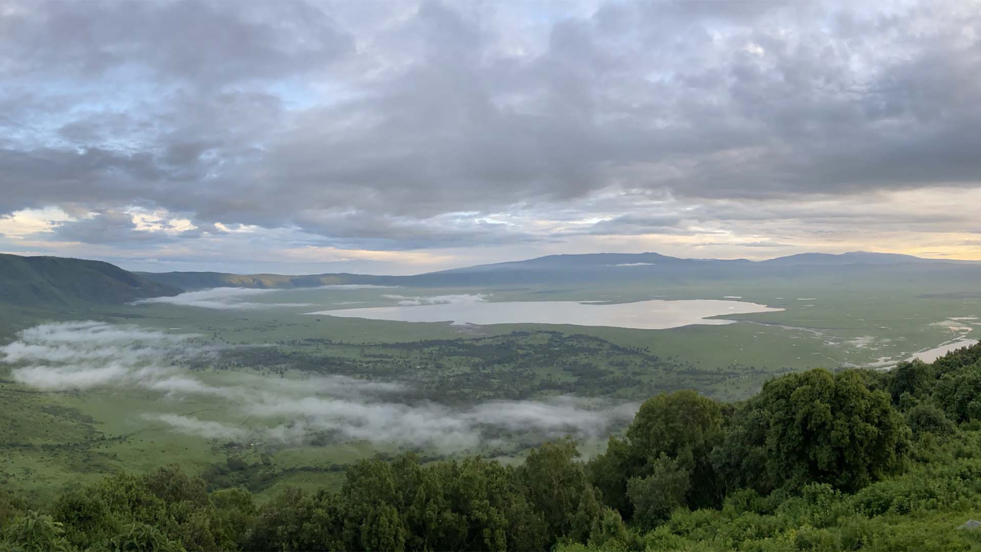 a landscape with trees and clouds_ngorongoro_crater